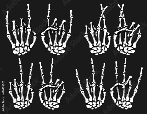 Skeleton of a human hand making rock sign, peace sign gesture, fingers crossed for good luck and shocker photo