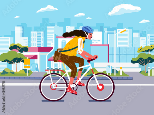 girl cycling on the road. young woman cycling to work wearing safety helmet and city scape as background