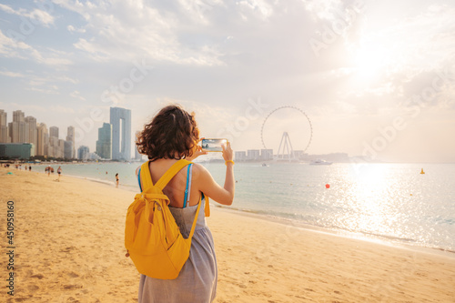 Photography Woman travel blogger takes pictures for social networks of skyscrapers on Bluewa