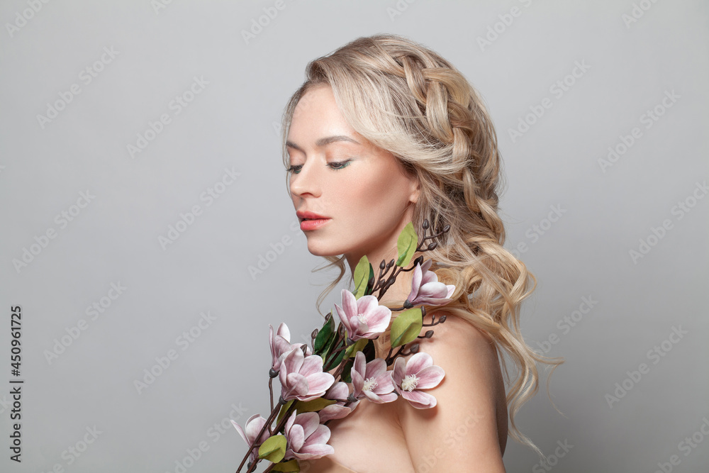 Healthy woman model with clean skin, light nude make-up, closed eyes and curly blonde hairstyle background