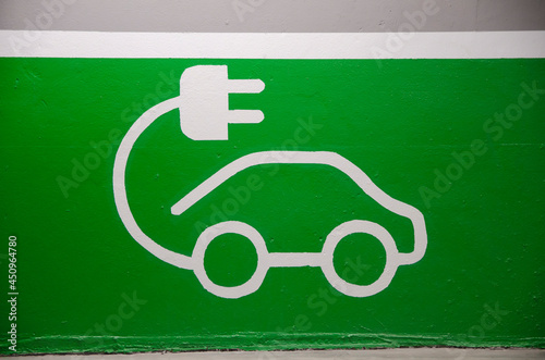 Roadsign of free electric car charging station in a European supermarket parking lot.  photo