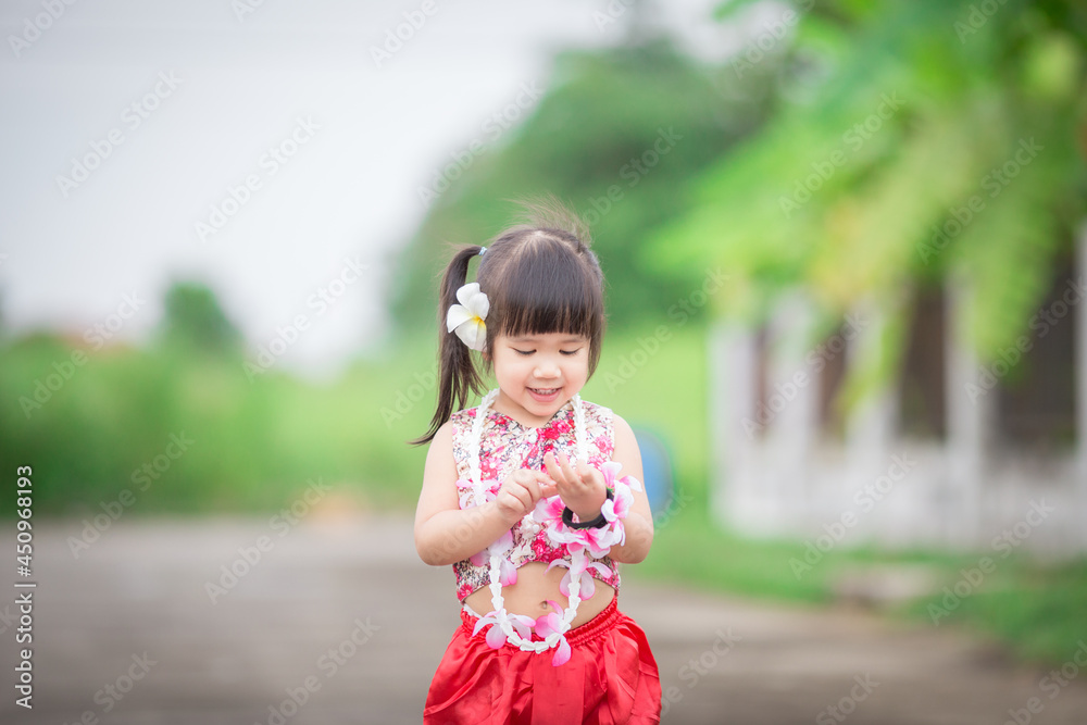 Close-up background view of a blurred Asian girl running or teasing in the street in front of the house, doing activities together outside the classroom during the holidays. Close-up background view of a blurred Asian girl running or teasing in the street in front of the house, doing activities together outside the classroom during the holidays.