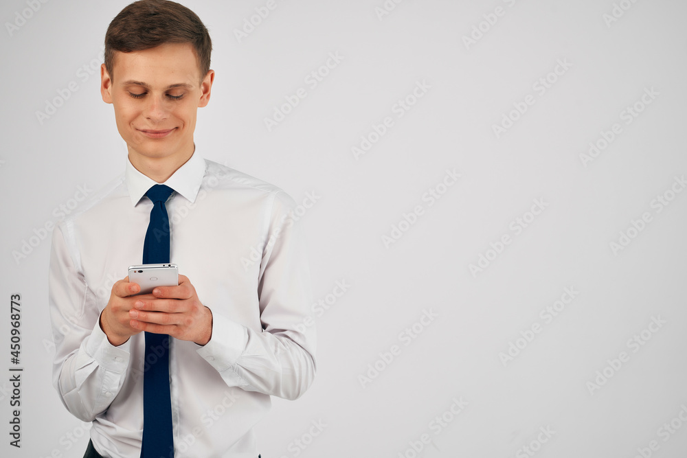 business man in a shirt with a tie with a phone in his hands communication business man in a shirt with a tie with a phone in his hands communication