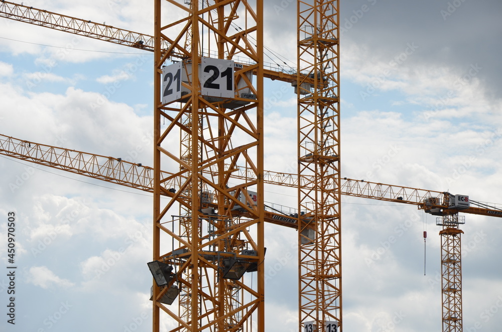 yellow tower cranes on huge construction site yellow tower cranes on huge construction site