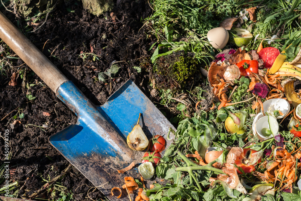 Compost box outdoors full with garden browns and greens and food wastes, blue shovel in the soil, sustainable life concept
Compost box outdoors full with garden browns and greens and food wastes, blue shovel in the soil, sustainable life concept