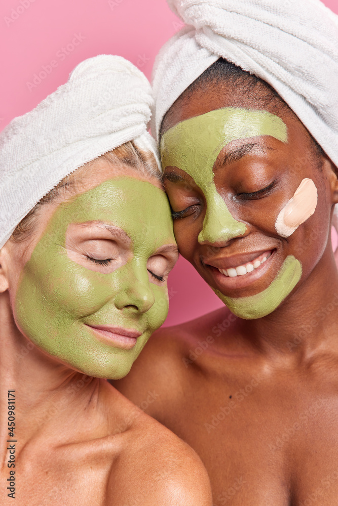 Vertical shot of multiethnic women of different age apply green natural