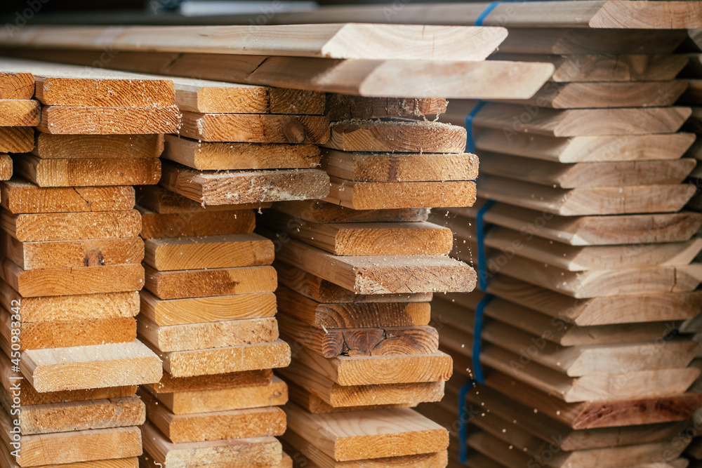 View of ends of stacked edged boards for construction of fence or cladding house. Timber prepaired for building View of ends of stacked edged boards for construction of fence or cladding house. Timber prepaired for building