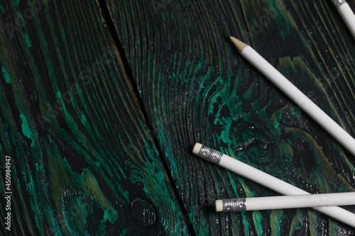 Fototapeta Naklejka Na Ścianę i Meble -  A set of white pencils for school. They lie on pine boards.