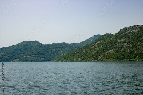 Croup of mountains around beautiful lake. Landscape on the natural park highlands. Panoramic view on the lakeshore.