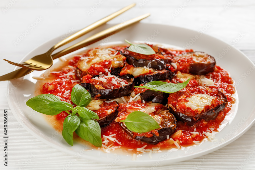 eggplant parmigiana on a white plate, top view eggplant parmigiana on a white plate, top view