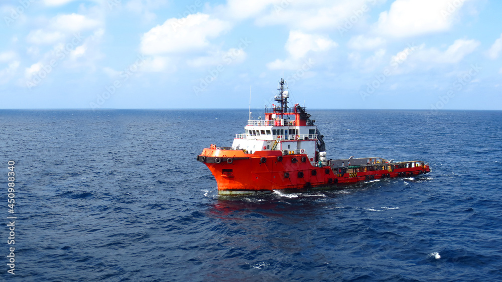 Supply boat transfer the cargo for supporting oil and gas industry and moving cargo from the boat to the platform. Boat is waiting transfer cargo and crews to platform. Supply boat transfer the cargo for supporting oil and gas industry and moving cargo from the boat to the platform. Boat is waiting transfer cargo and crews to platform.