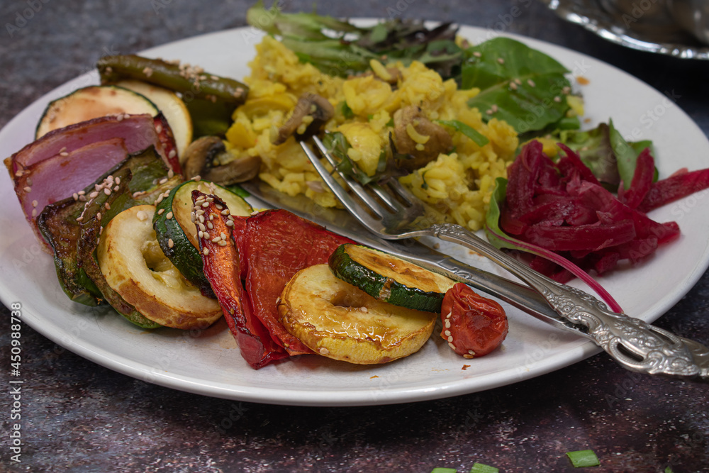 Vegan vegetables kabobs served on silver platter along with rice pilaf