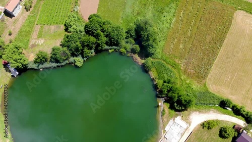 Aerial view to the natural lake with apple shape in Bosnia and Herzegovina. New tourist attraction in Gornji Vakuf city. 4K footage of beautiful landscape 