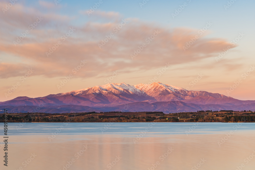 Beautiful sunrise at the lake (View of the Pic du Canigou, France Pyrenees Mountains)