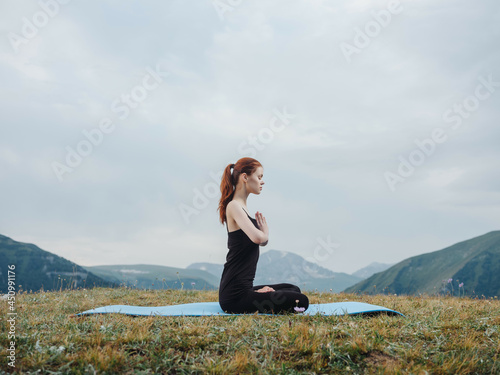 woman doing yoga outdoors in the mountains nature health