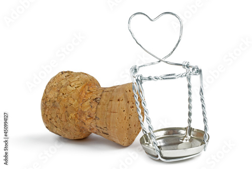 Champagne cork and wire cage with symbolical heart isolated on white background. Selective focus.