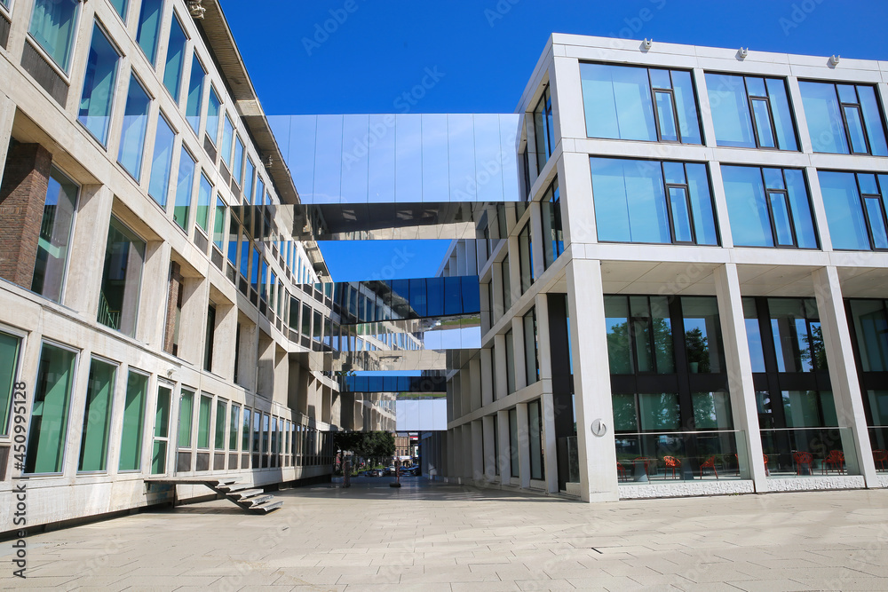 Arnhem (house of province), Netherlands - July 9. 2021: View on modern architecture office buildung with skybridges against blue summer sky