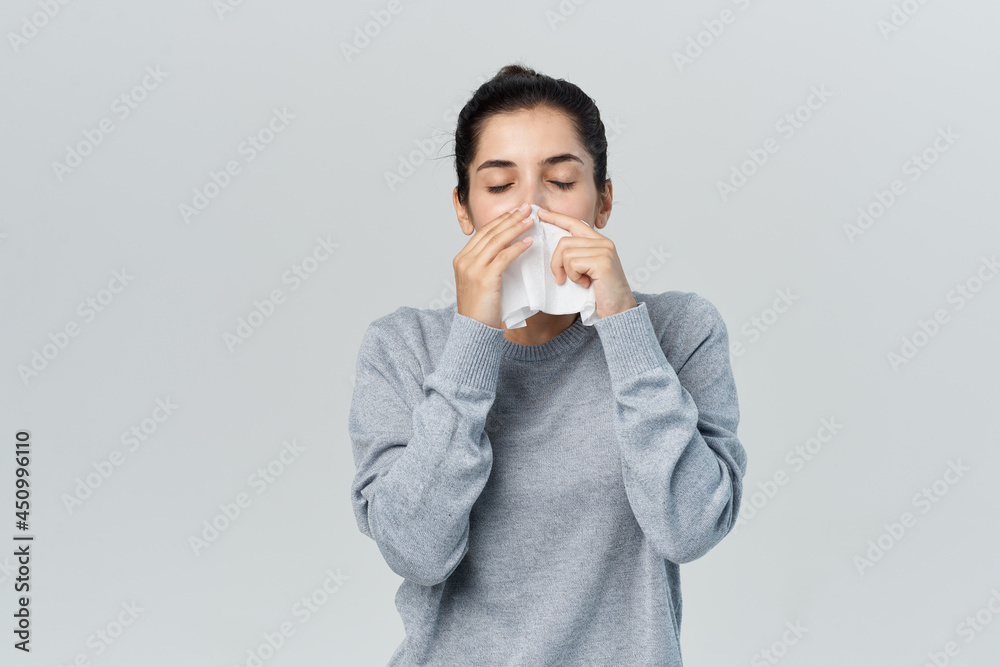 woman wiping her nose with a handkerchief health problems allergy infection woman wiping her nose with a handkerchief health problems allergy infection