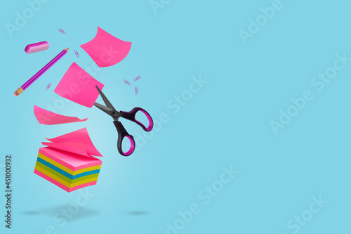 Creative idea made of notes, pieces of paper, pencil, eraser and scissors floating in the air.