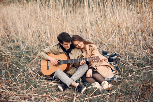 Beautiful couple spend time in a autumn field