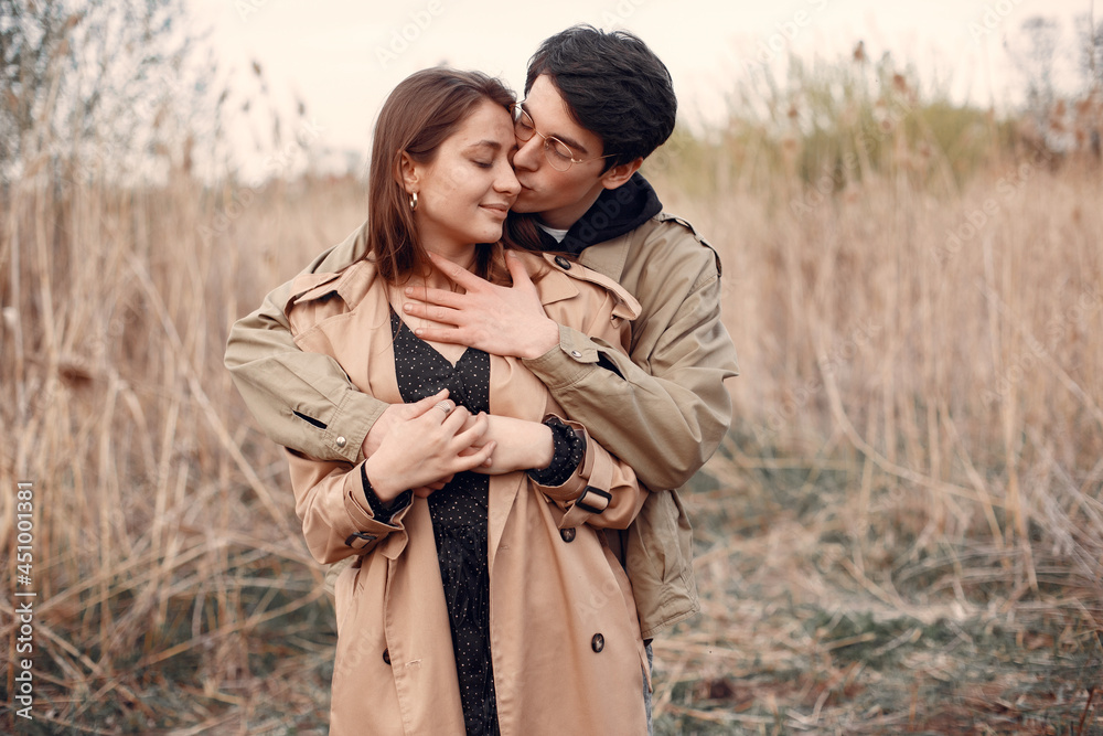 Beautiful couple spend time in a autumn field