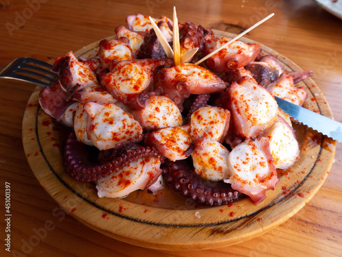 Quadro su tela Galician-style octopus a traditional Galician dish served on the wooden plate