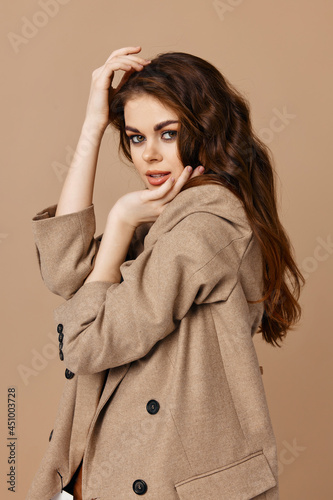 beautiful woman coat posing attractive look beige background