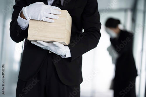 Bereaved holding urn at funeral
