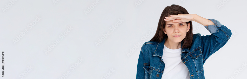 Young pretty woman with brown hair looking far isolated on white background Young pretty woman with brown hair looking far isolated on white background