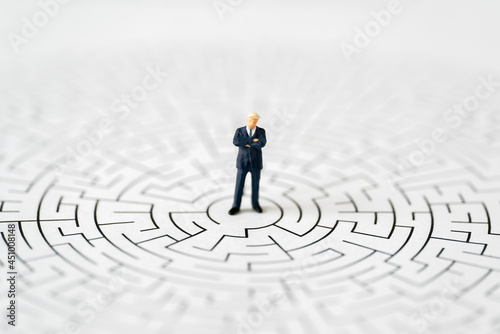 Miniature Business people office man stand center of maze thinking business plan and how to solve problem using for Accounting Financial Banking business growth development and Commerce Strategy Plan