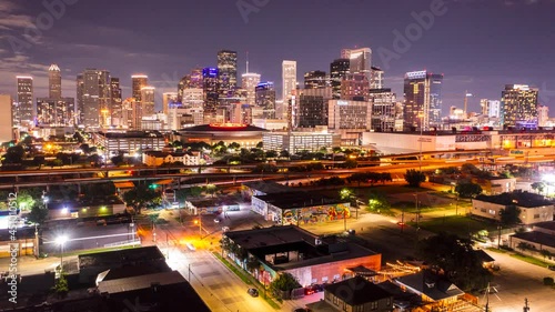 A time-lapse of the Houston skyline with cars speeding by in the foreground. 