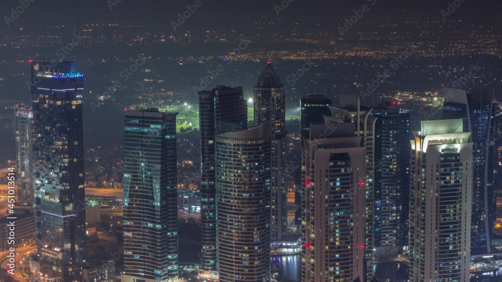 JLT skyscrapers near Sheikh Zayed Road aerial night timelapse. Residential buildings JLT skyscrapers near Sheikh Zayed Road aerial night timelapse. Residential buildings