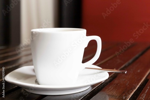 The coffee mug placed on brown wood table