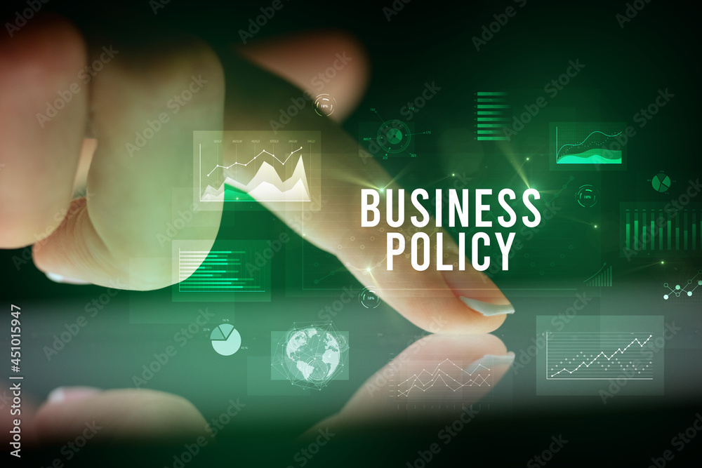 Finger touching tablet with business graphs and icons concept Finger touching tablet with business graphs and icons concept