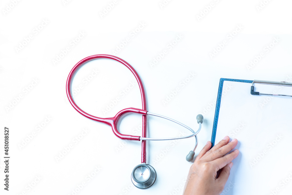The doctor uses a pen to write down the symptoms of the disease. at the white office A stethoscope was placed next to the recording paper. The doctor uses a pen to write down the symptoms of the disease. at the white office A stethoscope was placed next to the recording paper.