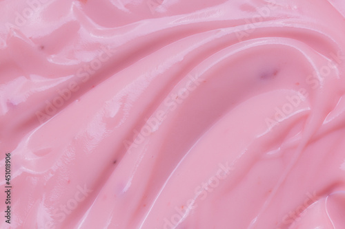 Macro Yogurt,Strawberry frozen yogurt background close up. Strawberry ice cream texture close up. Top view. Pink fruit ice cream background with small pieces of berries