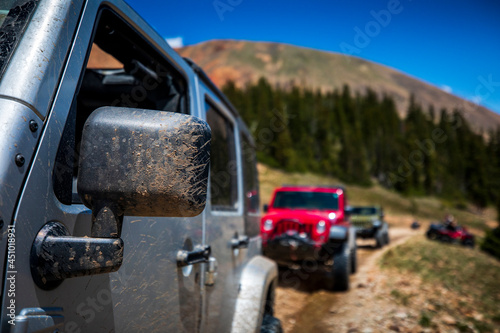 Mud covers the rear-view mirror of a vehicle while 4-wheeling up Revenue Mountain in the Upper Geneva Creek area near Grant, Colorado. photo