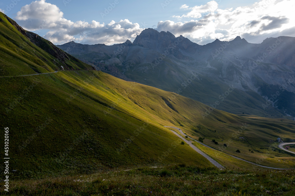 Paysage de haute montagne dans les hautes-Alpes autour du col du Lautaret avec des rayons de lumière sur le relief en été