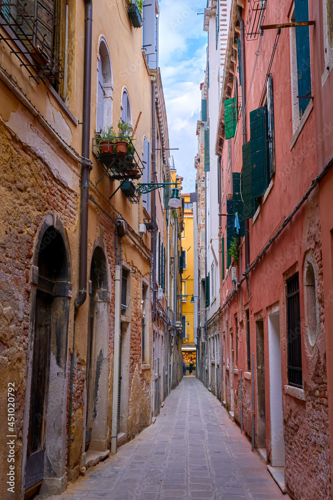 Old narrow streets or calles of Venice, Italy. Medieval atmosphere, shabby and empty alleyways, UNESCO World heritage city.