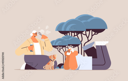 senior couple blowing bubbles and spending time with little dog relaxation retirement concept full length