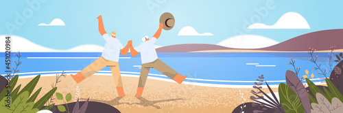 senior couple dancing old man and woman having fun active old age concept seascape background