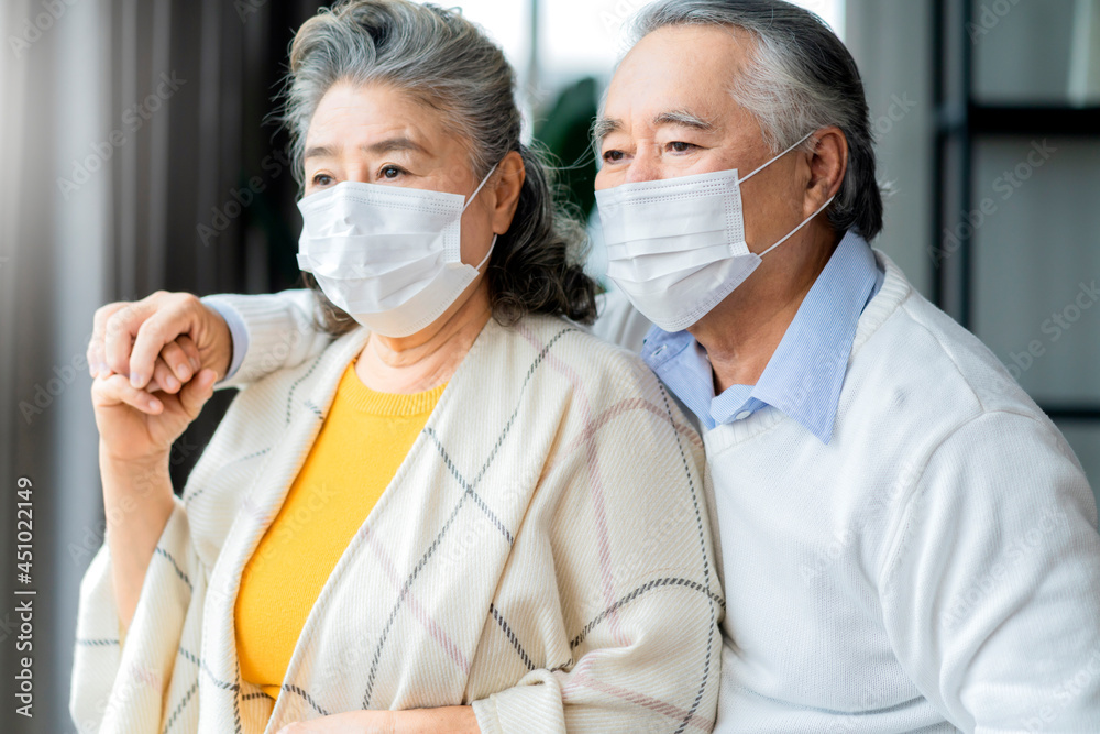 asian retired elderly couple wearing face masks watch the world through their home window hand hug and support together,asian people home isolation social distancing stay home ideas concept asian retired elderly couple wearing face masks watch the world through their home window hand hug and support together,asian people home isolation social distancing stay home ideas concept