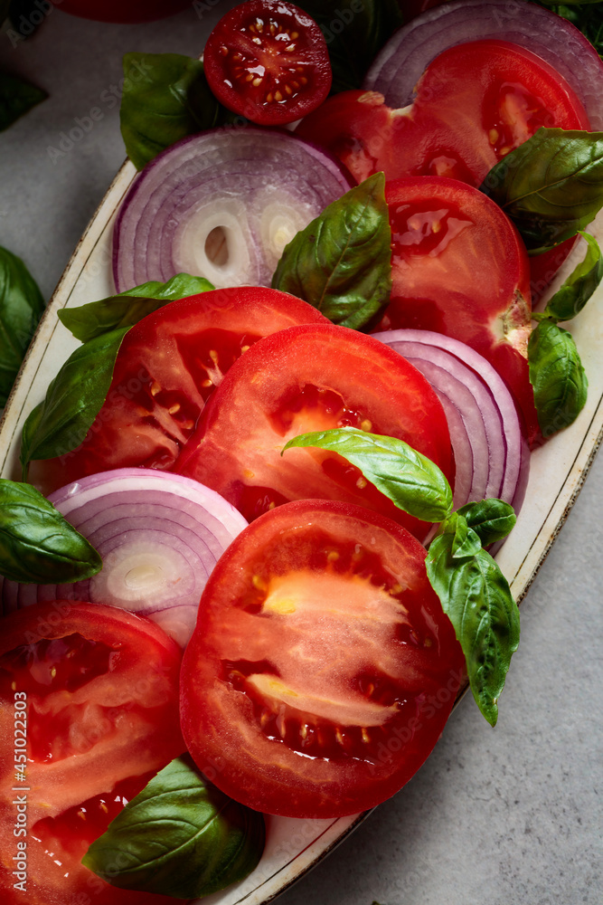 Salad with tomatoes, basil, and red onion. Salad with tomatoes, basil, and red onion.