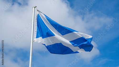 The St. Andrew Cross, national flag of Scotland, flying in the wind, photo