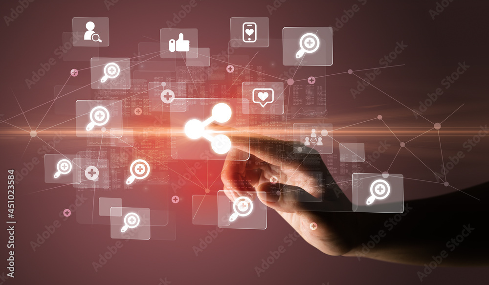 Hand pressing social media multimedia application screen with media icons on futuristic concept Hand pressing social media multimedia application screen with media icons on futuristic concept