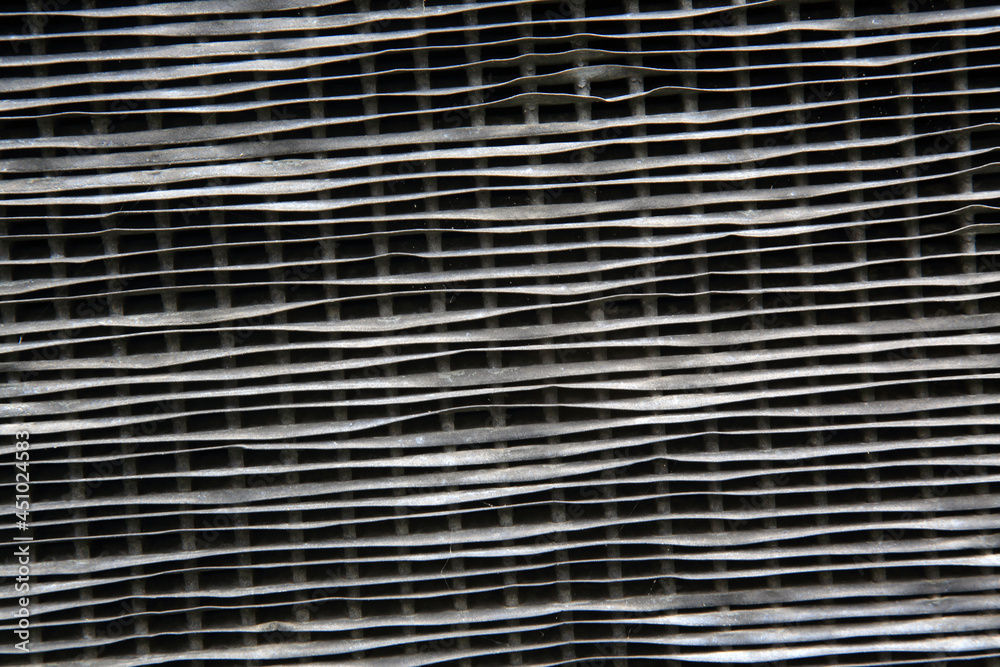 Grille of a classic car with bent fins from damage