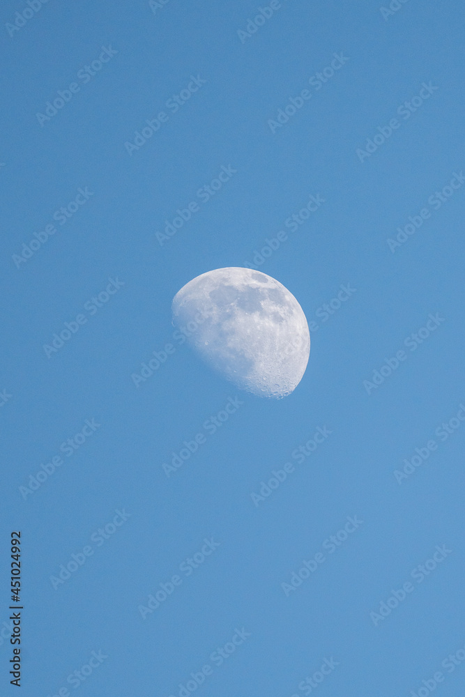 partial moon at dusk on blue sky partial moon at dusk on blue sky