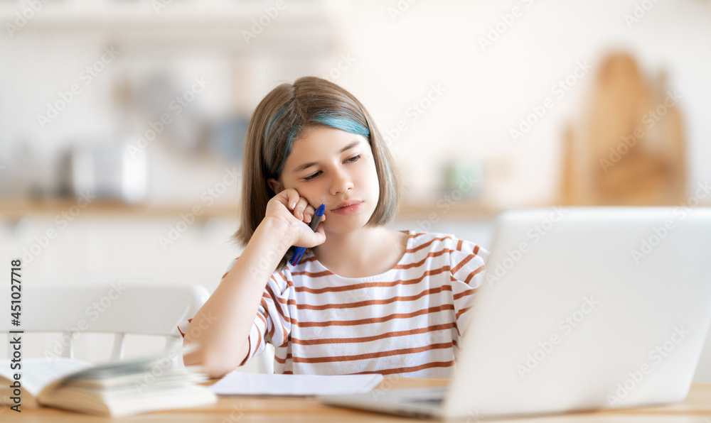 Girl doing homework or online education. Girl doing homework or online education.