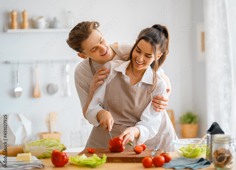 loving couple is preparing the proper meal loving couple is preparing the proper meal