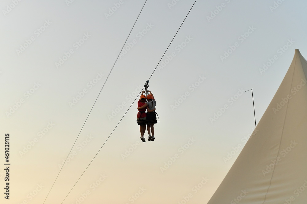 Children descend on a rope at high speed on a swing in an extreme
